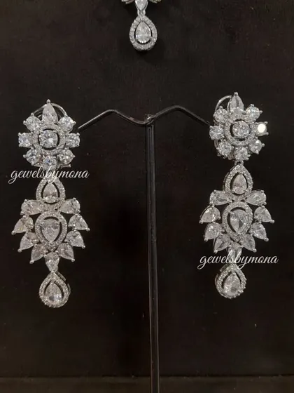 A pair of exquisite diamond earrings from a bridal set. These pieces are designed with intricate floral and geometric patterns to create a look of dazzling elegance, perfect for a bride or any grand occasion.