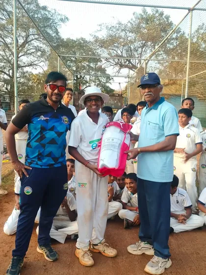 A young player receiving his kit bag as a reward for his performance in the MPL U-14 tournament.