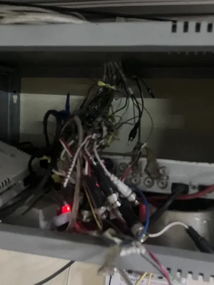 This is what we often find: a tangled mess of wires behind a DVR. This kind of setup is a fire hazard and the main reason for system failures, blurry footage, and recording gaps.