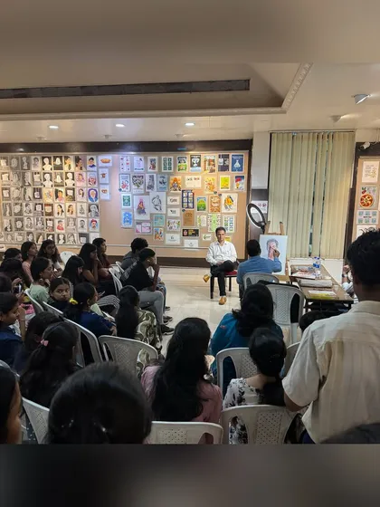 Another angle showing the large audience of students gathered to watch the live watercolour portrait session.