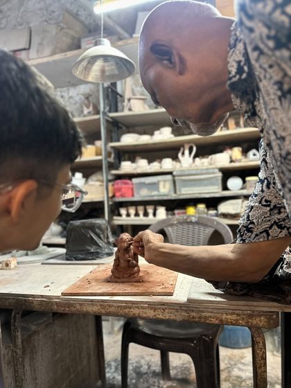 A close-up of me guiding a young participant. Teaching the next generation to create with their hands is at the heart of what we do.