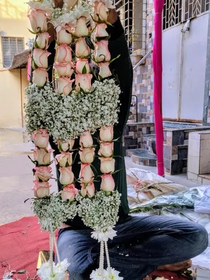 We handcraft custom jaimala garlands that are as unique as your love story. This particular varmala design features delicate pink roses interspersed with clusters of baby's breath, offering a modern and romantic alternative to traditional garlands.