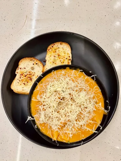 My Pink Sauce Pasta served with two slices of crispy garlic bread. It's a complete and satisfying meal.