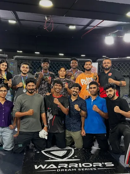The team celebrating inside the cage after a successful night at the Warrior's Dream Series. The bond we share is our greatest strength.