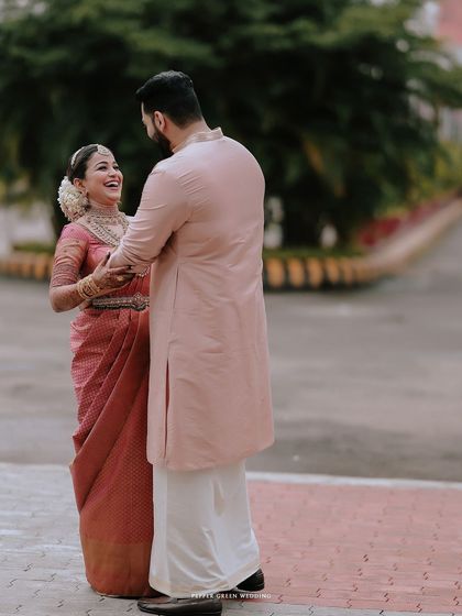 A candid moment of the couple sharing a laugh, their happiness evident in this lovely portrait.