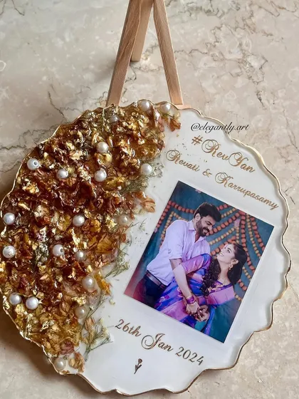 Capture your special moment for eternity. This frame features intricate varmala designs on one side and an unforgettable photo on the other, complete with the couple's hashtag and wedding date.