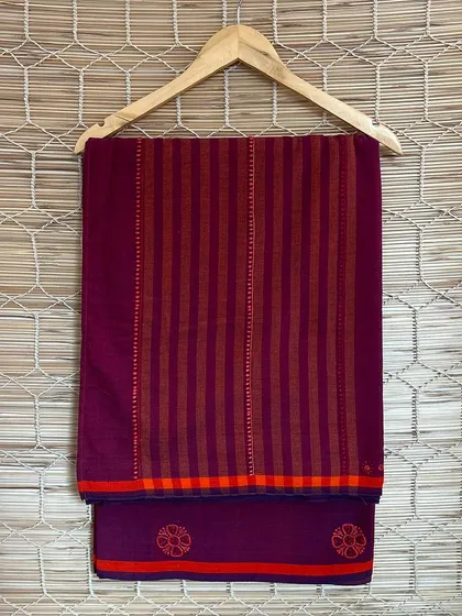 This purple handloom saree features a striped pallu and delicate floral embroidery. It's a perfect example of how we blend traditional techniques with contemporary color palettes.