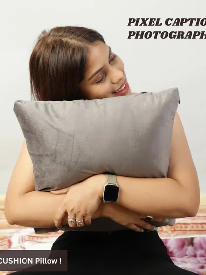 A candid shot of a model hugging a soft grey cushion. This image evokes a sense of comfort and coziness, which is a key selling point for pillows.