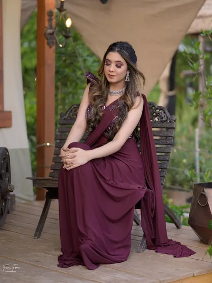 A full-length shot of this modern cocktail look. The draped saree is so chic, and the makeup adds a touch of drama.