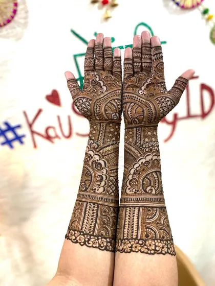 A full-arm mehendi design set against a festive backdrop. The intricate patterns create a stunning visual, perfect for any celebration.