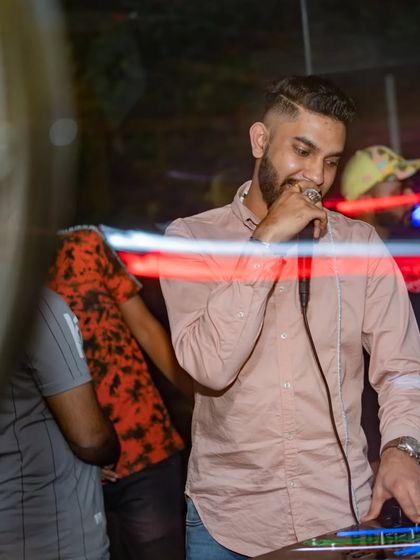 Grabbing the mic to hype up the crowd. I'm not just a DJ who plays music; I'm an entertainer who interacts with the audience to elevate the party to the next level.