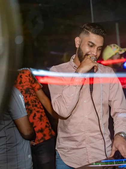 Grabbing the mic mid-mix to hype the crowd. It's a seamless blend of DJing and MCing, ensuring the energy never drops.