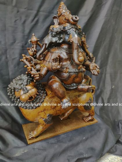 This perspective highlights the powerful stance of the lion and the detailed ornamentation on Lord Ganesha in the Heramba Ganapati wax model.