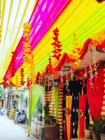 A long view of the street-side tent, showing how it transforms a public space into a private, festive corridor for the event.