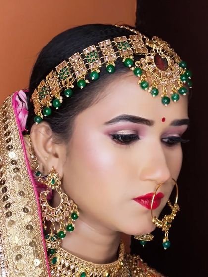 A side profile of the same bride, showing the intricate details of her matha patti and earrings.