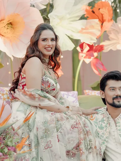 Janvi looking like a princess in her floral wonderland. Her makeup is kept fresh and glowing, allowing her natural beauty and the stunning decor to shine.