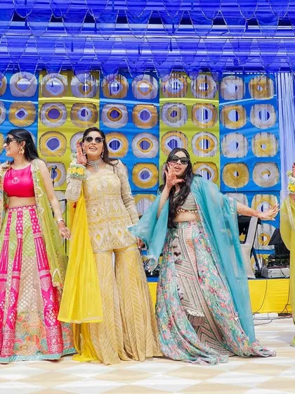The bride's squad posing with their sunglasses on, bringing all the swag to the mehendi.