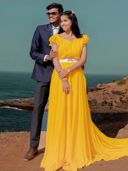 Walking into their future together. This couple's pre-wedding shoot by the sea is made brighter with this beautiful yellow trail gown.