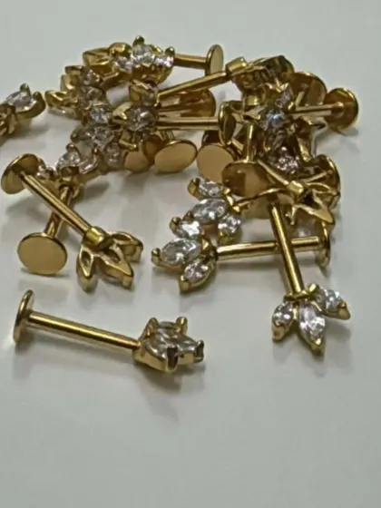 A close-up of our gold-plated Bugadi studs. These are perfect for adding a touch of ethnic elegance to your helix or upper cartilage piercing.