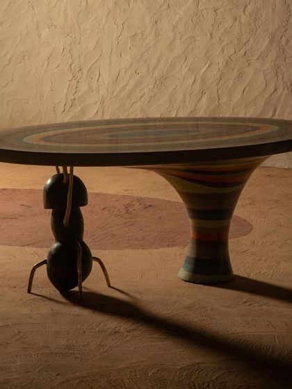 The Weavers Ant Table is where the ant becomes the architect. This piece creates a harmonious balance of art and nature, with a colorful, patterned top supported by a whimsical yet strong base.