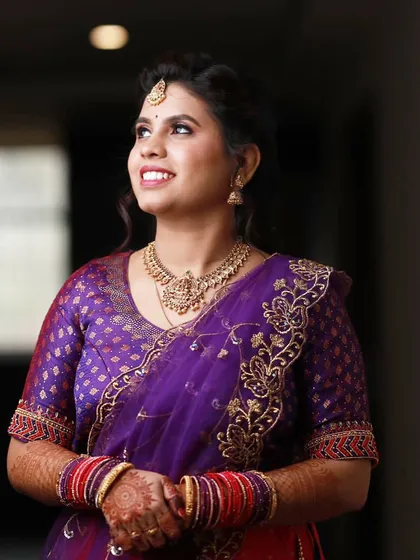 A candid shot of the bride looking up, her face lit with happiness.