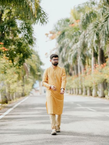 A stylish portrait of the groom in a yellow kurta, ready for his Haldi ceremony.