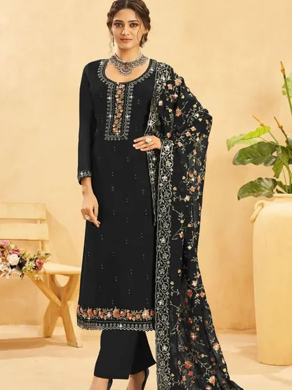 This black salwar kameez is a timeless beauty. The colorful thread embroidery and sequins on the neckline and dupatta add a pop of festive cheer to the classic black.