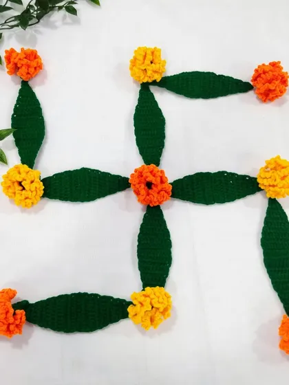 My loose crochet flowers can be used to create beautiful, reusable rangoli designs. This swastik pattern was made using my handmade marigold flowers and mango leaves, bringing an auspicious and eco-friendly touch to your festive decor.