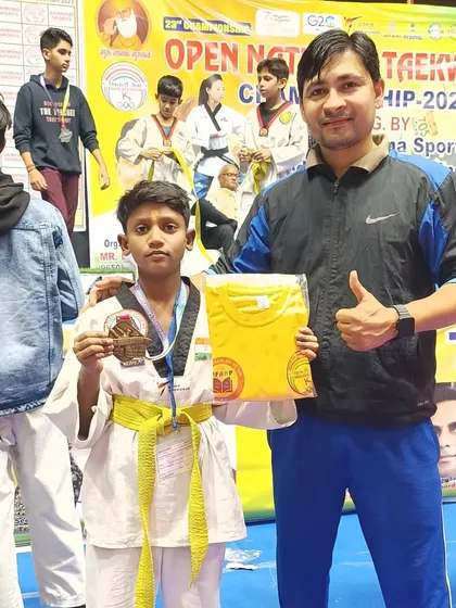 This young fighter earned a bronze medal and a prize t-shirt for his performance.