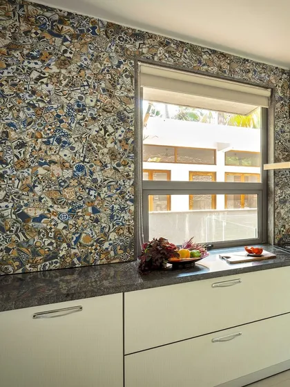The backsplash in this kitchen is a unique, custom-designed tile mosaic that adds a burst of personality and artistic flair. It transforms a functional wall into a captivating focal point, showcasing our love for bespoke details.