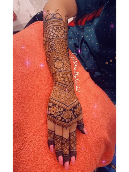 The other arm of the engagement mehendi, featuring a beautiful geometric design with floral bands.