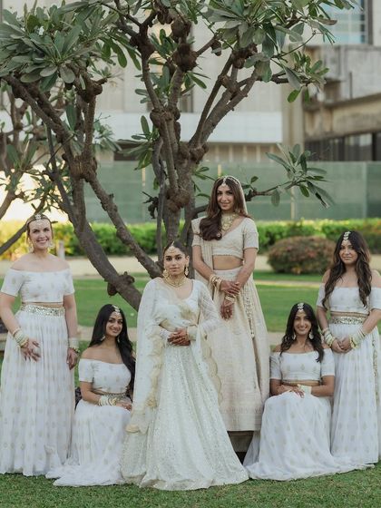 A beautiful portrait of the bride with her bridesmaids, all dressed in elegant white outfits. This shot celebrates the friendship and support of her bride tribe.