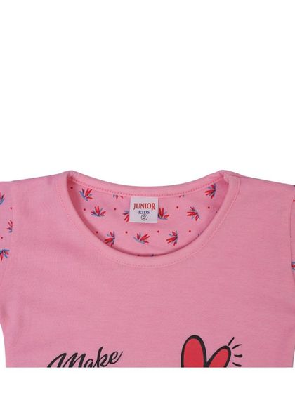 A close-up of the neckline of the pink top.