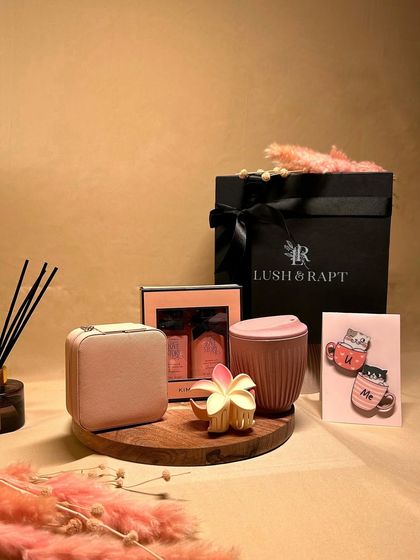 The 'Blissful Treasures' hamper is a collection of charming and practical gifts. It includes a stylish mug, a mini jewelry box, cute magnets, and a pampering kit.