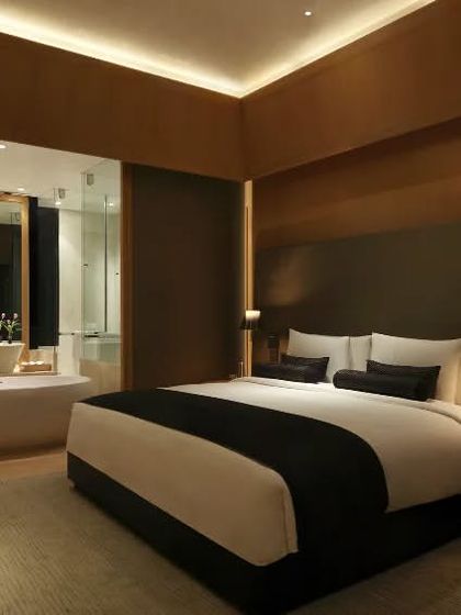 This view shows the layout of one of our luxury rooms, where the bedroom and bathroom spaces flow into each other, creating a sense of openness and modern comfort.