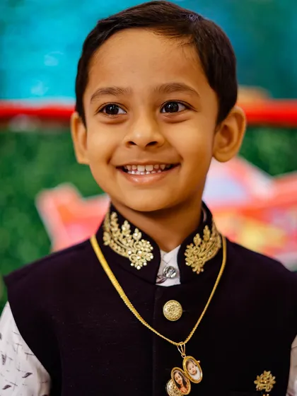 A close-up portrait of a young boy's happy smile at his birthday party. I make sure to capture the genuine joy of children during their special celebrations.