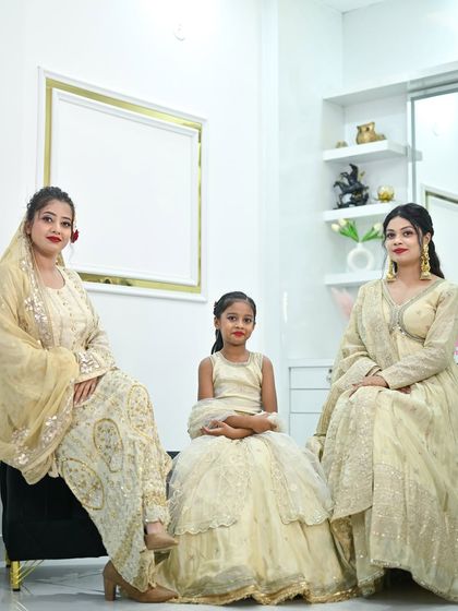 A beautiful family portrait with everyone dressed in my ivory and gold collection. It shows options for different age groups, from a sharara suit to an Anarkali and a kids' lehenga.