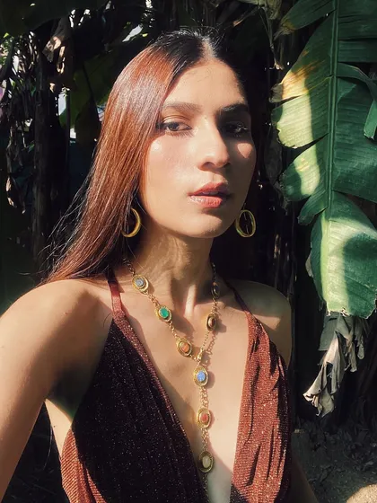 A direct, confident portrait from the Tirbari shoot, letting the beautiful, multi-colored gemstone jewelry take center stage.
