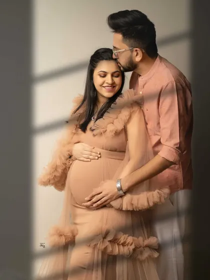 Love in light and shadow. I love playing with natural light to create artistic and romantic portraits that feel both modern and timeless, like this tender moment between expecting parents.