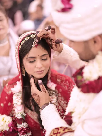 The Sindoor ceremony, where the groom applies vermilion to the bride's hair parting, symbolizing their new status as a married couple. A truly emotional moment.