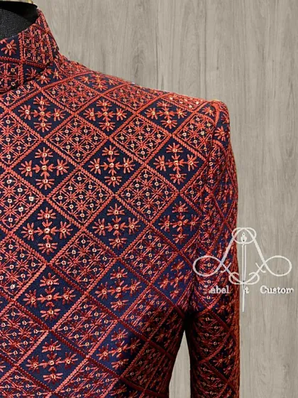 A close-up of a navy and red embroidered Bandhgala. The intricate threadwork on the shoulder is a perfect example of how I use details to create a sophisticated look.