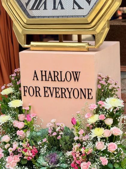 A beautiful floral installation surrounds a display for Fossil's Harlow watch collection. The combination of soft pink flowers and elegant branding created a sophisticated and feminine atmosphere for the product launch.