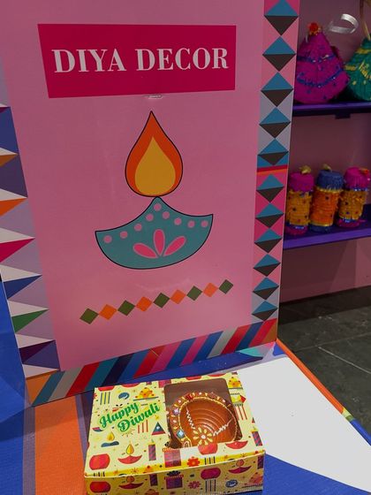 Clear, colorful signage helps kids know what activities are available. This 'Diya Decor' sign marks the spot for one of our most popular Diwali activities.