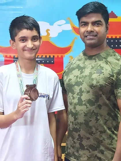 I believe in personally guiding each champion. Here I am with one of our talented students after her win at the Open National Karate Championships, celebrating another step forward.