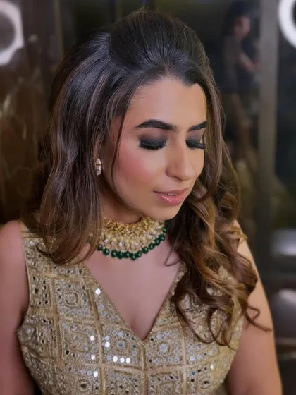 This shot highlights the texture of the soft waves and the flawless blend of the smokey eye makeup. It's a perfect example of a bold yet elegant party look.