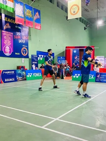 Our coach in action during a competitive doubles match at the Agra Badminton Premier League. This on-court experience is directly translated into the training our players receive.