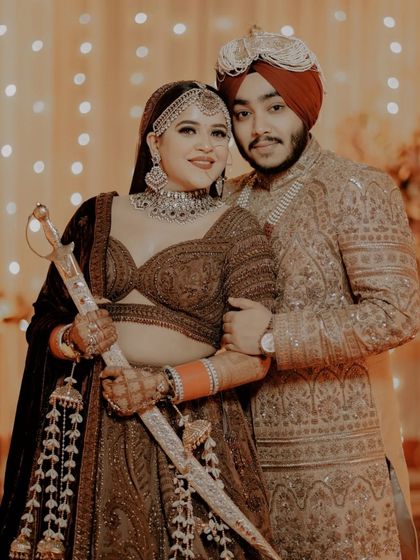 A powerful and playful portrait of Vanshita and Prabneet, with the bride holding the groom's kirpan, symbolizing their partnership.