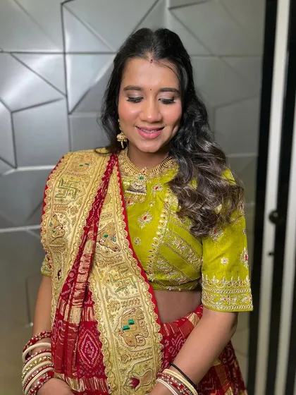 The makeup features a soft, shimmery eye and a flawless base, ensuring she looks radiant for her special day.