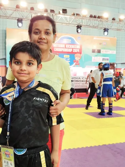 A young athlete with his mother at the national championship. We believe family support is a crucial part of an athlete's journey to success.