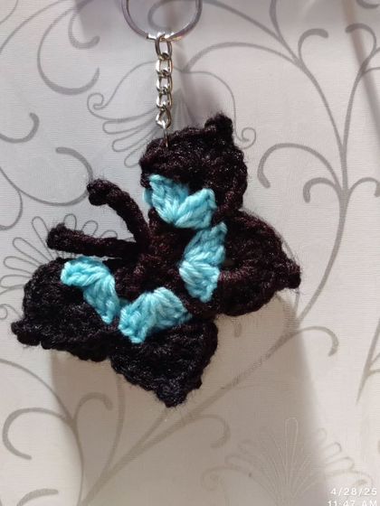 Elegant black butterfly keychains with pops of color like orange, blue, pink, purple, and yellow on the wings.